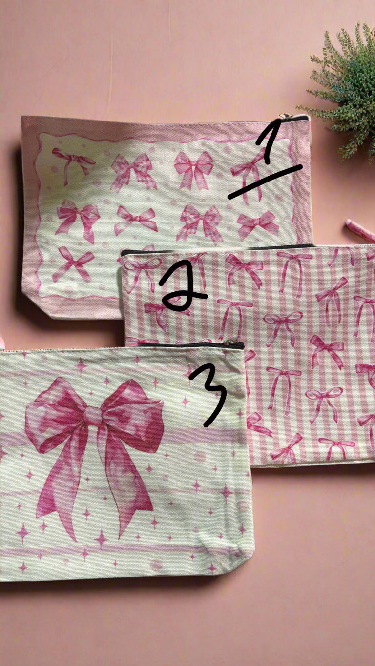 Two pink pouches with bow designs on a black background